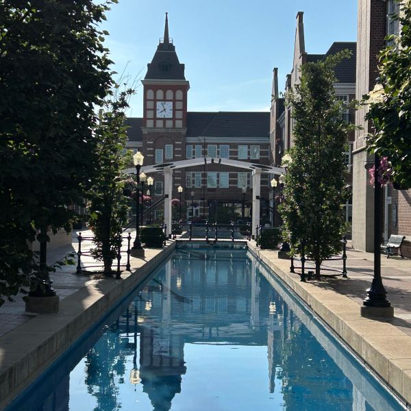 a building with a clock on the side of a river